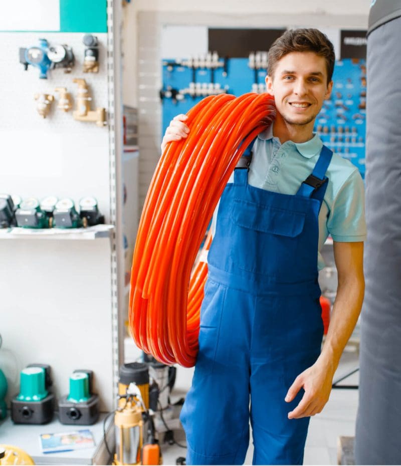 plumber-holds-pipe-roll-in-plumbering-store-2021-08-27-09-27-30-utc-1-800x930